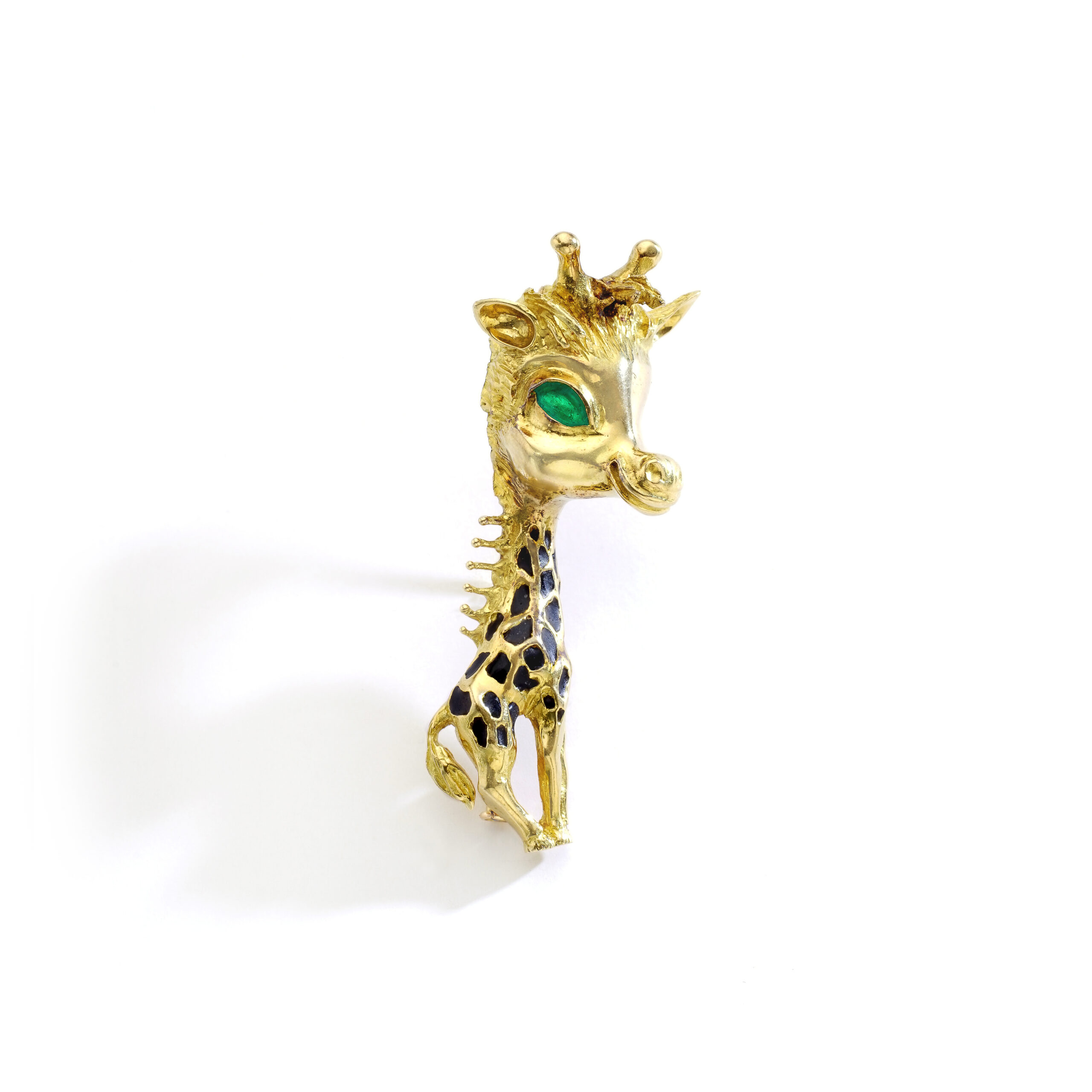 Front view of a French Gold Giraffe Brooch. Size: 6cm. The giraffe has one large green eye and 22 black giraffe spots.