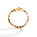 Side view of a snake bracelet in yellow gold. this bracelet features a unique and intricate snake motif design that is both elegant and timeless.