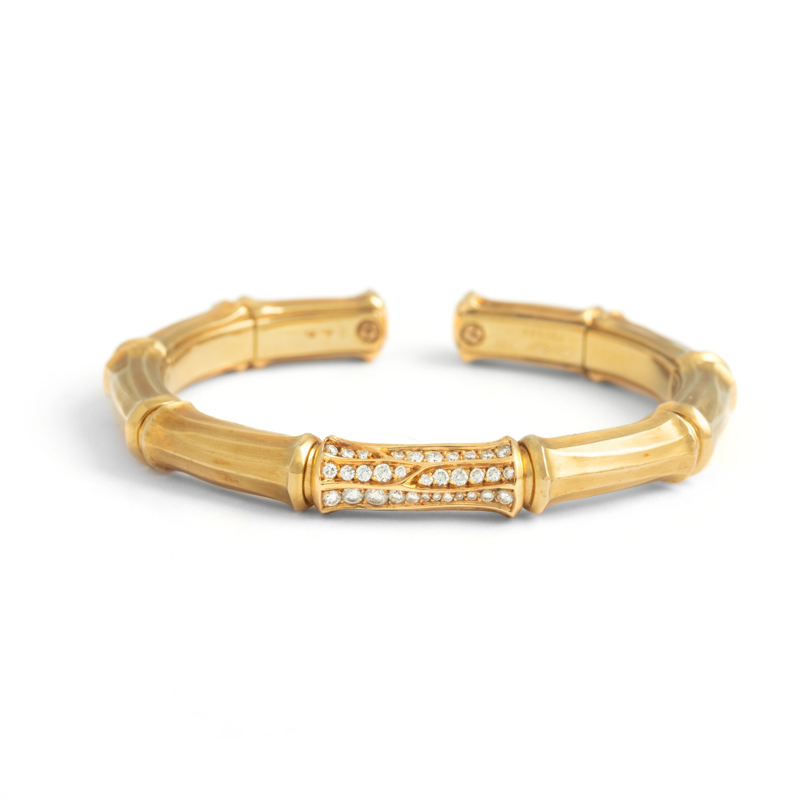 Front view of the Cartier Bangle Bamboo. The bracelet has a bamboo structure and looks as if it has 9 bamboo elements, the middle one is set with diamonds