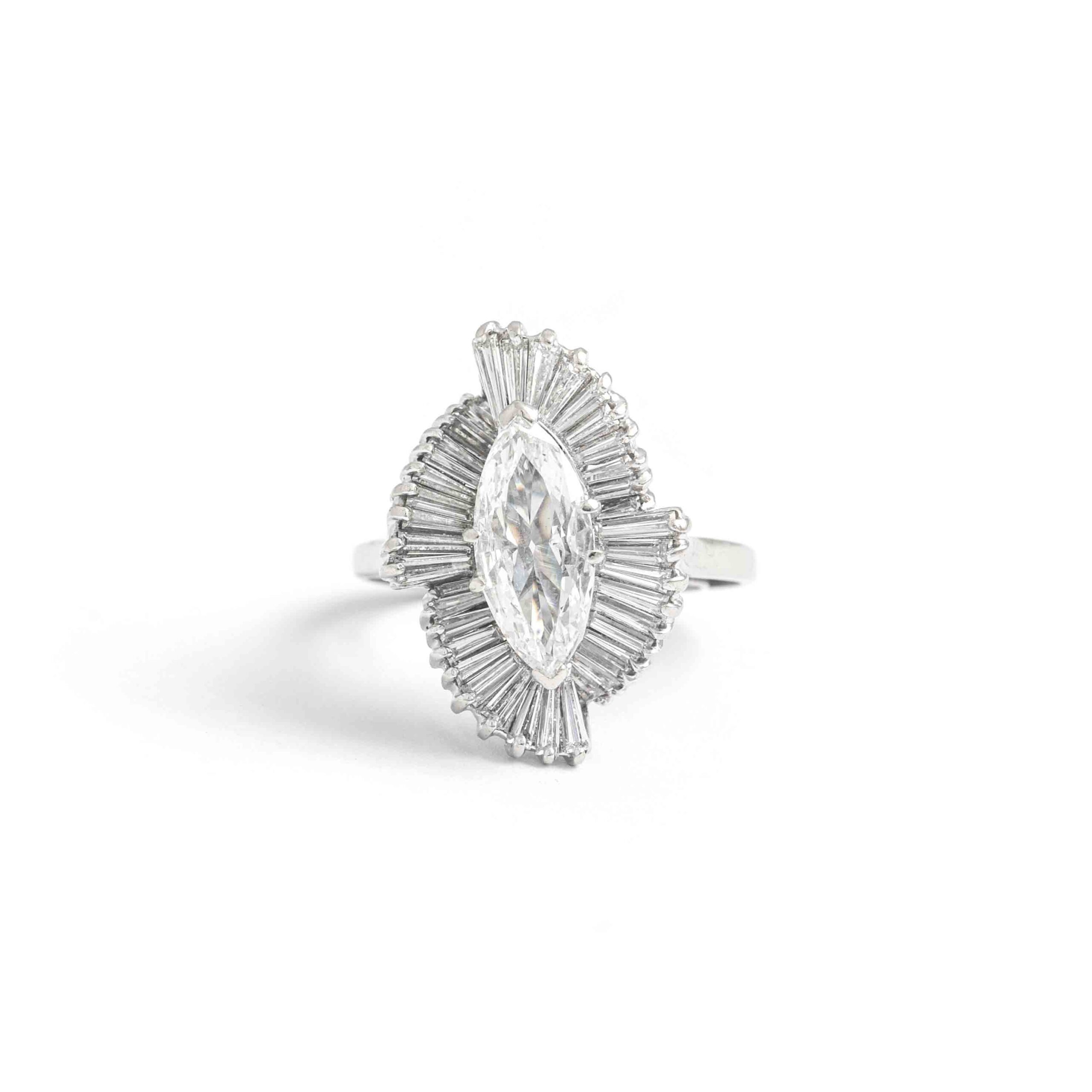 1.38 Carat Marquise Diamond White Gold 14K Ring. The central marquise Diamond weights 1.38 carat, F color and Si2 clarity, No fluorescence surrounded by baguette cut diamond. Circa 1950.