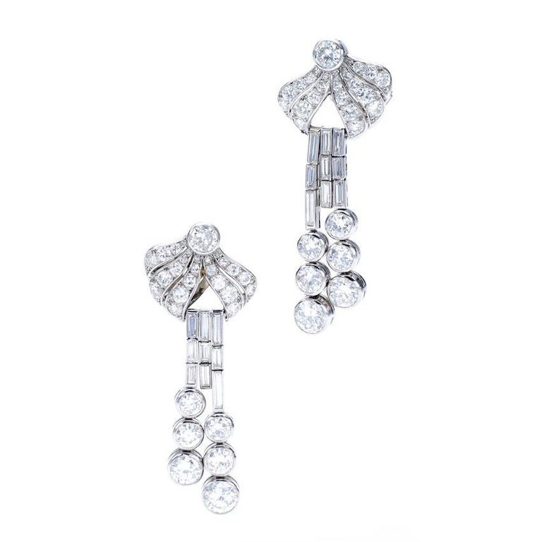 A pair of Diamond and Platinum Earrings. Old mine cut and Baguette cut Diamond. French marks. Circa 1940. Total Length: approximately 2.00 inches (5.00 centimeters).