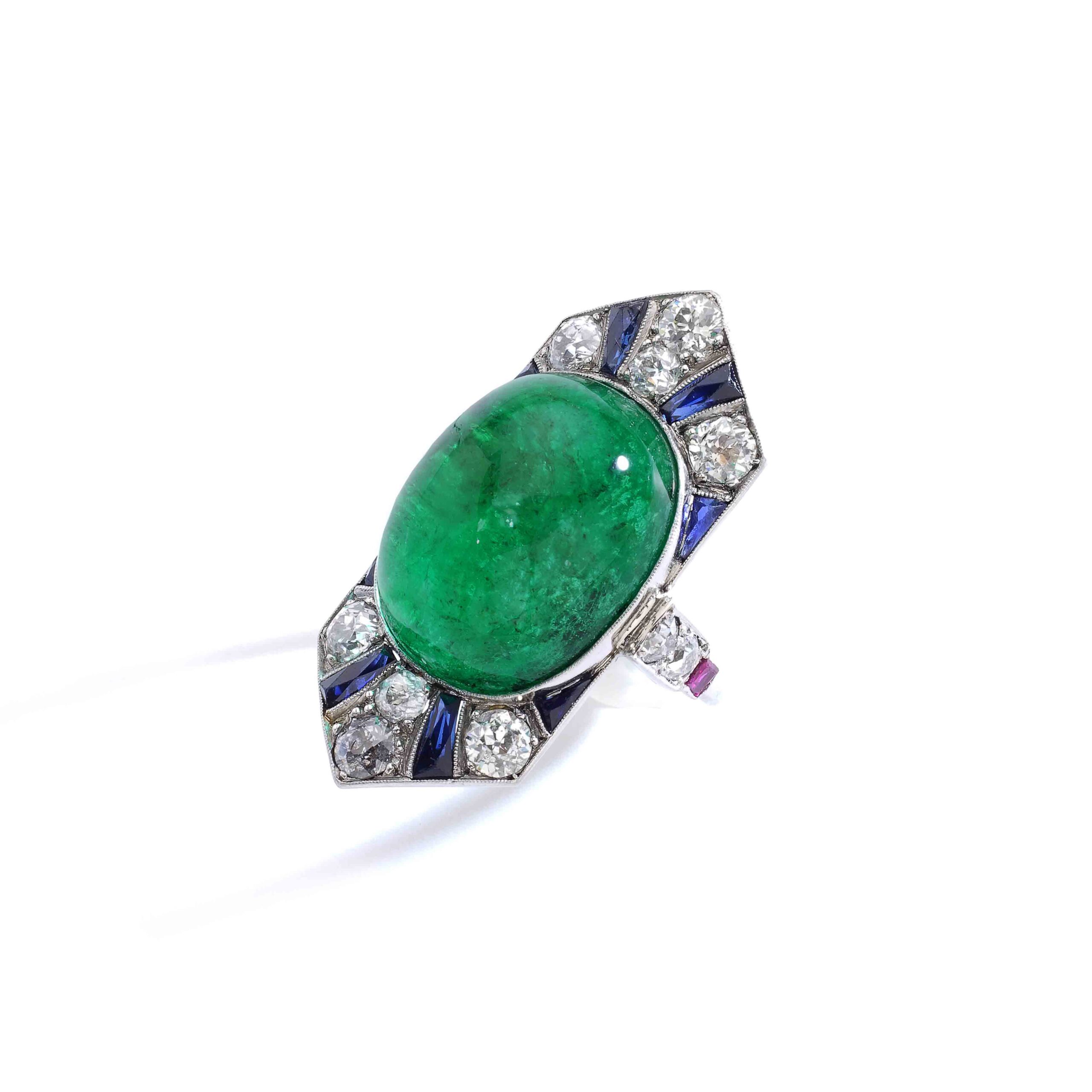 Henri Picq, Art Deco ring in sapphires, rubies, and old-cut diamonds on platinum centered with a significant Colombian emerald of approximately 30.00 carats in cabochon cut. French workmanship. Circa 1925. Master jeweler hallmark of Henri Picq, who was one of the most important high jewelry workshops in Paris at the beginning of the 20th century, having created numerous pieces for the houses on Place Vendôme, primarily Cartier